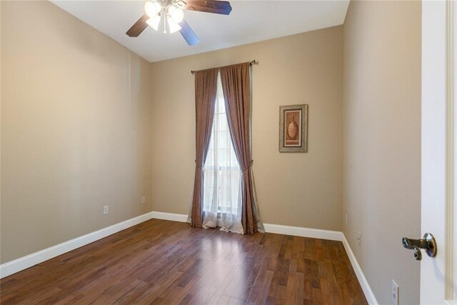 unfurnished room featuring a ceiling fan, baseboards, and wood finished floors