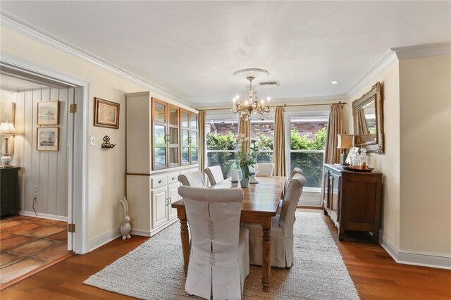 3705 Clifford Dr, Metairie, LA 70002 - dining area with visible vents, ornamental molding, wood finished floors, baseboards, and a notable chandelier