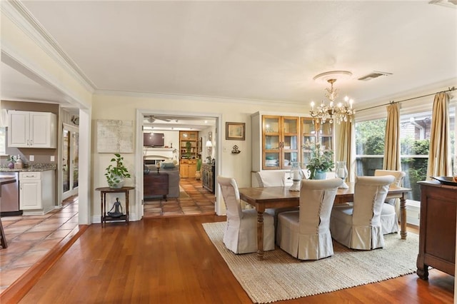 3705 Clifford Dr, Metairie, LA 70002 - dining space featuring crown molding, wood finished floors, a notable chandelier, and visible vents