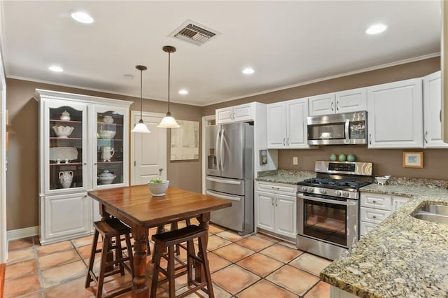 3705 Clifford Dr, Metairie, LA 70002 - kitchen with visible vents, ornamental molding, white cabinets, hanging light fixtures, and stainless steel appliances