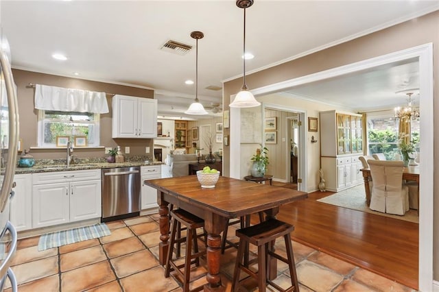 3705 Clifford Dr, Metairie, LA 70002 - kitchen featuring stainless steel dishwasher, ornamental molding, visible vents, a healthy amount of sunlight, and white cabinets