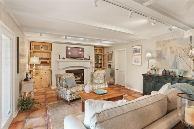 3705 Clifford Dr, Metairie, LA 70002 - living room featuring rail lighting, a fireplace, tile patterned floors, and beam ceiling
