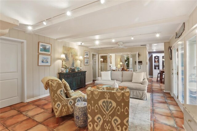 3705 Clifford Dr, Metairie, LA 70002 - tiled living area featuring track lighting, a ceiling fan, a decorative wall, and beamed ceiling