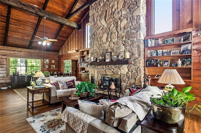 living area featuring a ceiling fan, wood finished floors, wooden ceiling, high vaulted ceiling, and beamed ceiling
