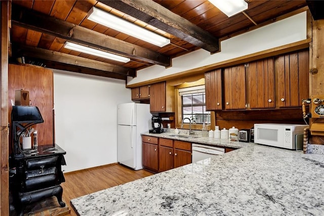 kitchen with wood ceiling, brown cabinets, a sink, white appliances, and light wood-style flooring