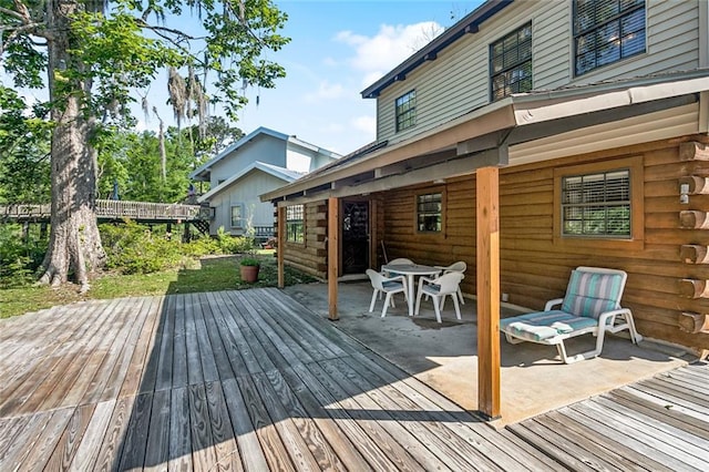 wooden terrace with outdoor dining area