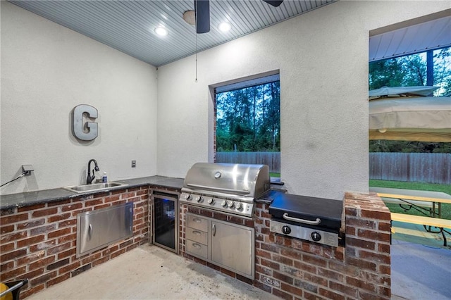 view of patio / terrace with grilling area, exterior kitchen, and fence