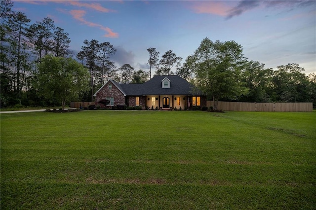 view of front of house featuring a front lawn and fence