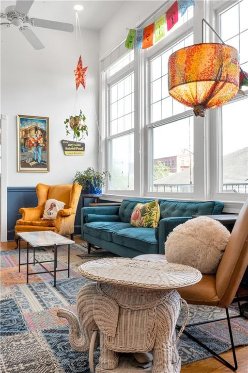 4716 Annunciation St Unit 2E, New Orleans, LA 70115 - sitting room featuring a towering ceiling, ceiling fan, and wood finished floors