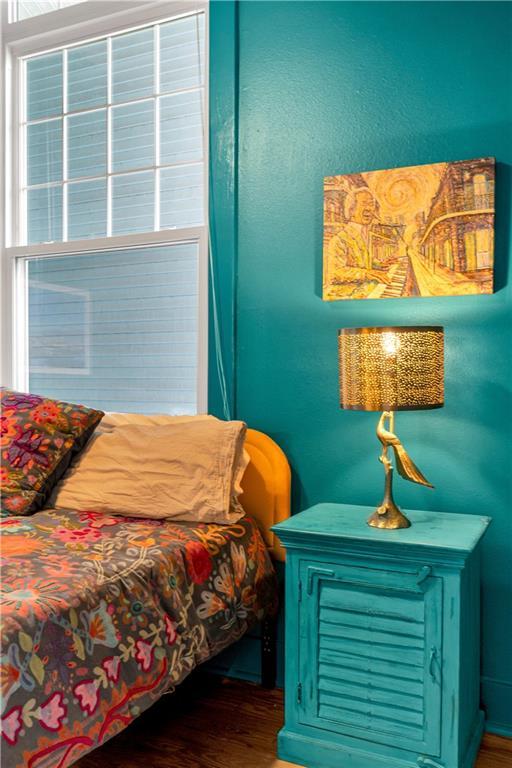 4716 Annunciation St Unit 2E, New Orleans, LA 70115 - bedroom featuring wood finished floors and multiple windows