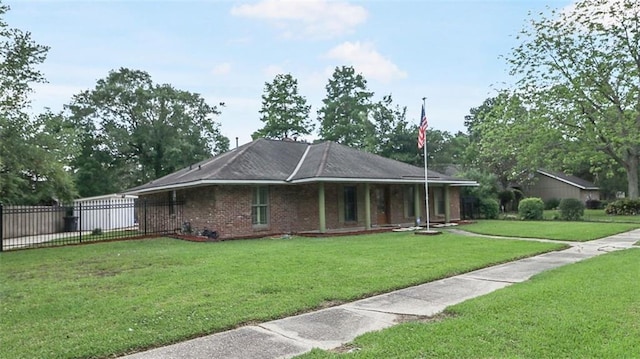 exterior space with brick siding, fence, a yard, and covered porch