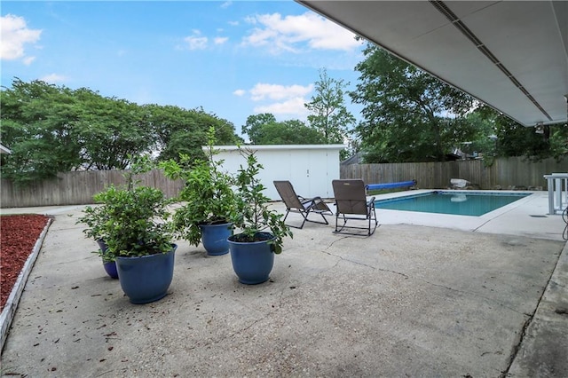 view of swimming pool with a fenced backyard, a fenced in pool, and a patio
