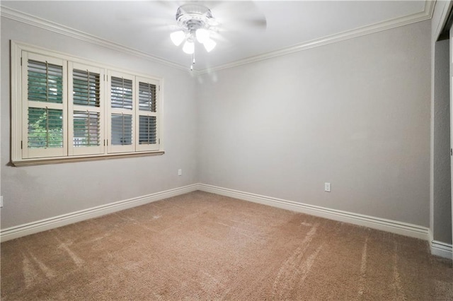 spare room with carpet floors, ceiling fan, ornamental molding, and baseboards