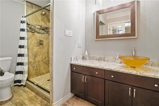 bathroom featuring toilet, a shower stall, ornamental molding, and vanity