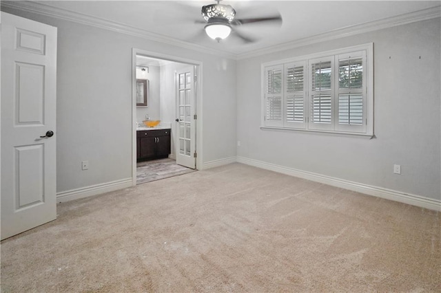 unfurnished bedroom with crown molding, baseboards, light carpet, and french doors