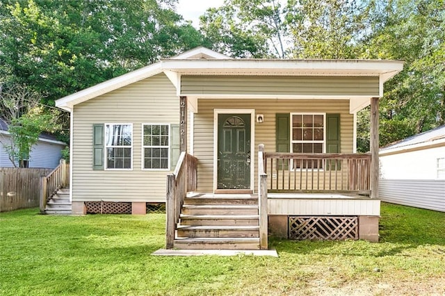 21221 Fern St, Covington, LA 70435 - view of front of property with covered porch, fence, and a front yard