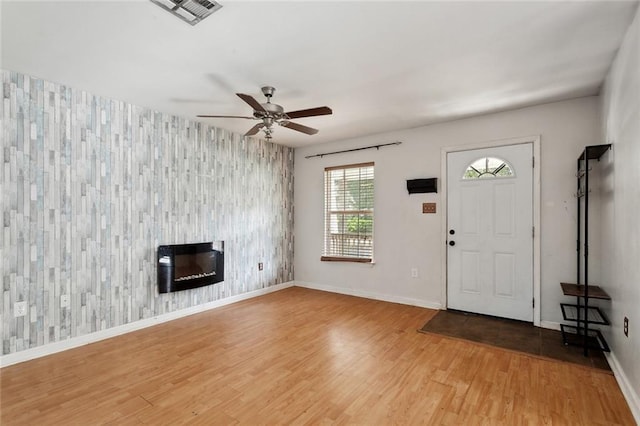 21221 Fern St, Covington, LA 70435 - foyer entrance with light wood-style floors, an accent wall, a ceiling fan, baseboards, and visible vents