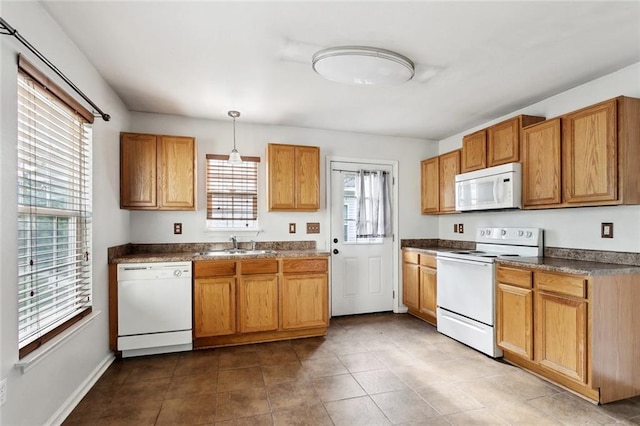 21221 Fern St, Covington, LA 70435 - kitchen with pendant lighting, dark countertops, white appliances, dark tile patterned floors, and a sink