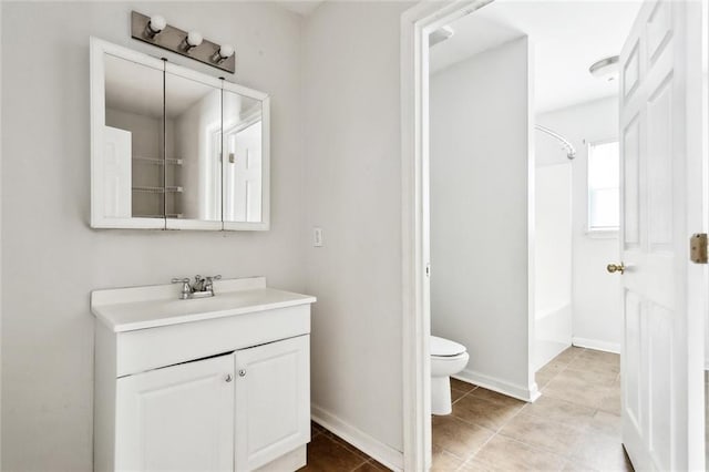21221 Fern St, Covington, LA 70435 - bathroom featuring washtub / shower combination, vanity, toilet, tile patterned floors, and baseboards