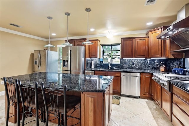 3808 Thomas Dr, Slidell, LA 70458 - kitchen with stainless steel appliances, visible vents, decorative backsplash, and a center island