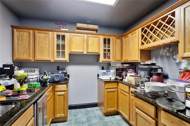 3808 Thomas Dr, Slidell, LA 70458 - kitchen featuring dark stone counters, light tile patterned floors, glass insert cabinets, and wine cooler