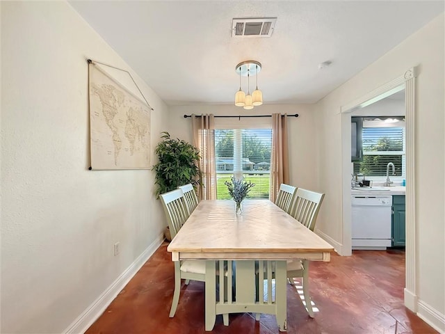 dining space with baseboards, concrete floors, and visible vents