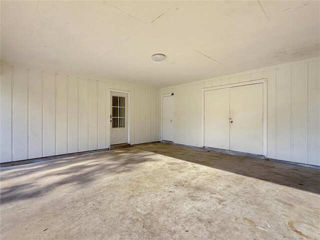 unfurnished bedroom featuring unfinished concrete flooring
