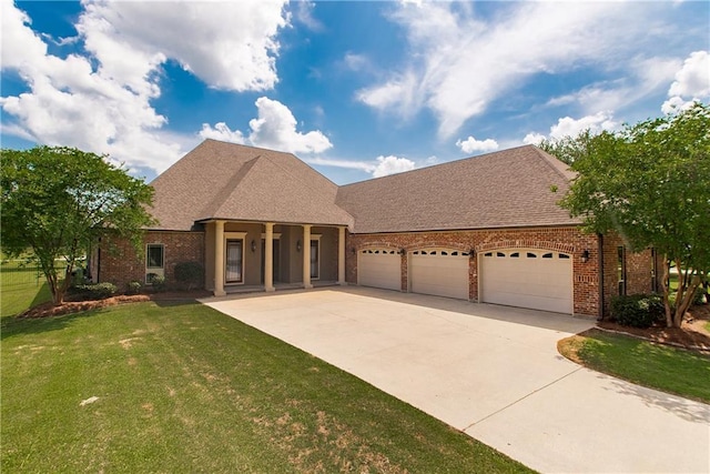 14208 W Hoffman Rd, Hammond, LA 70403 - view of front of house featuring a porch, a front yard, brick siding, concrete driveway, and an attached garage