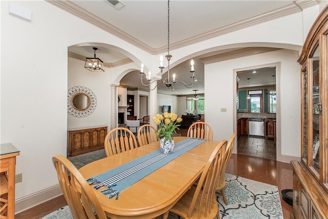 14208 W Hoffman Rd, Hammond, LA 70403 - dining area featuring visible vents, crown molding, arched walkways, dark wood finished floors, and a notable chandelier
