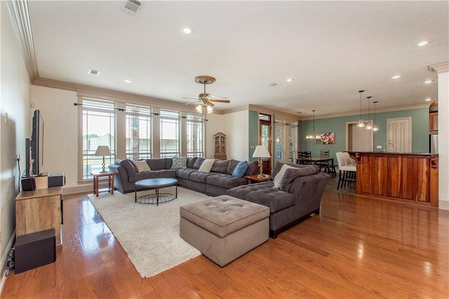14208 W Hoffman Rd, Hammond, LA 70403 - living area featuring visible vents, baseboards, crown molding, and wood finished floors