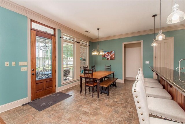 14208 W Hoffman Rd, Hammond, LA 70403 - dining area with visible vents, baseboards, stone tile flooring, a chandelier, and ornamental molding