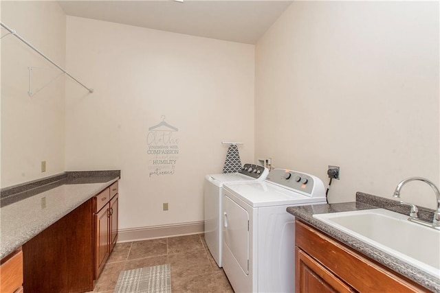 14208 W Hoffman Rd, Hammond, LA 70403 - laundry area featuring baseboards, a sink, cabinet space, independent washer and dryer, and light tile patterned floors