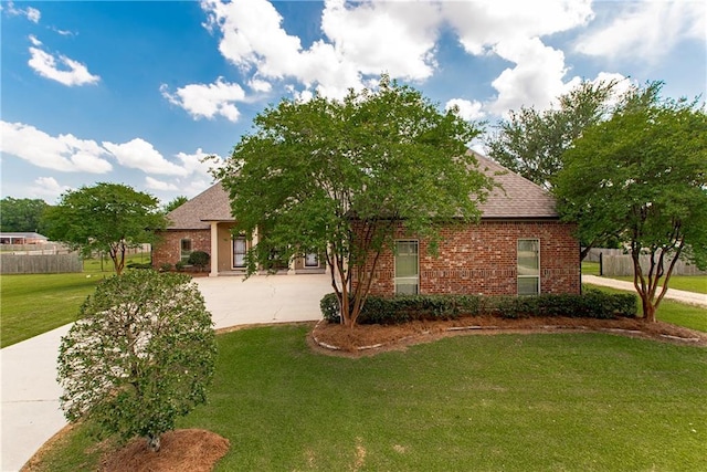 14208 W Hoffman Rd, Hammond, LA 70403 - view of front of home featuring a shingled roof, concrete driveway, a front lawn, and brick siding