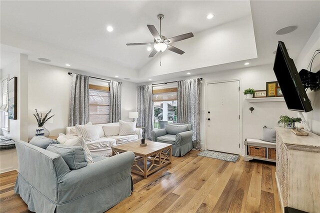 living room with recessed lighting, ceiling fan, vaulted ceiling, and light wood-type flooring
