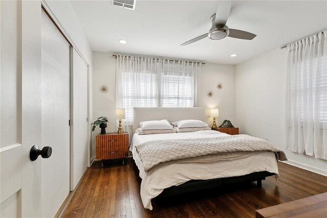 bedroom featuring a closet, recessed lighting, wood finished floors, and visible vents