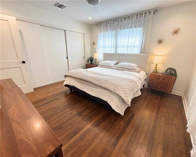 bedroom featuring visible vents, wood finished floors, and a closet