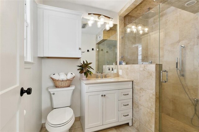 full bath with vanity, tile patterned flooring, a shower stall, and toilet