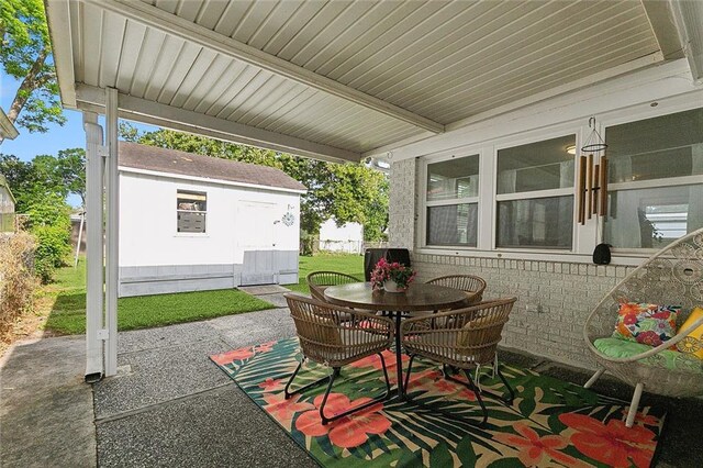 view of patio featuring an outdoor structure and outdoor dining space