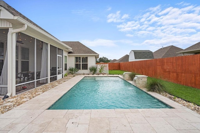 view of swimming pool with a fenced in pool, a fenced backyard, and a sunroom