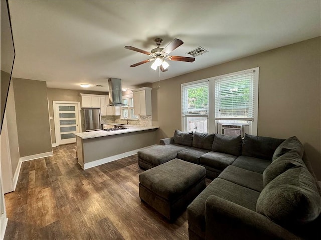 living room with visible vents, baseboards, ceiling fan, dark wood-style floors, and cooling unit