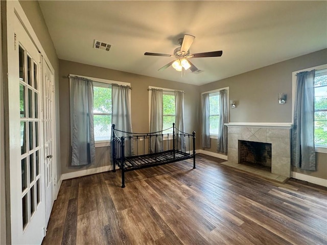 interior space with baseboards, multiple windows, and wood finished floors