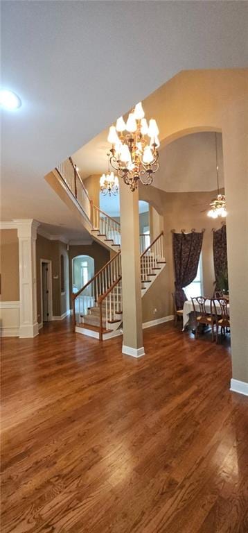 1045 Whitetail Dr, Mandeville, LA 70448 - entryway featuring stairs, wood finished floors, arched walkways, a chandelier, and baseboards