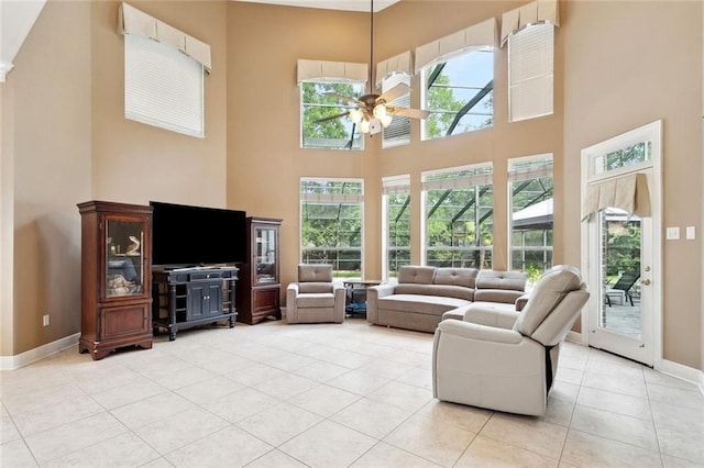 1045 Whitetail Dr, Mandeville, LA 70448 - living room with a towering ceiling, a ceiling fan, light tile patterned floors, and baseboards