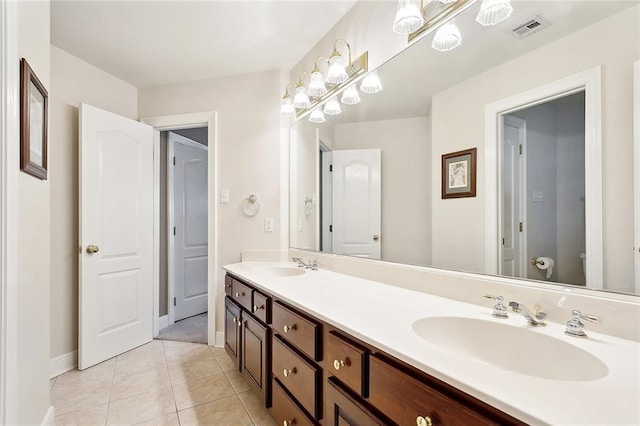1045 Whitetail Dr, Mandeville, LA 70448 - full bath featuring double vanity, baseboards, tile patterned flooring, and toilet