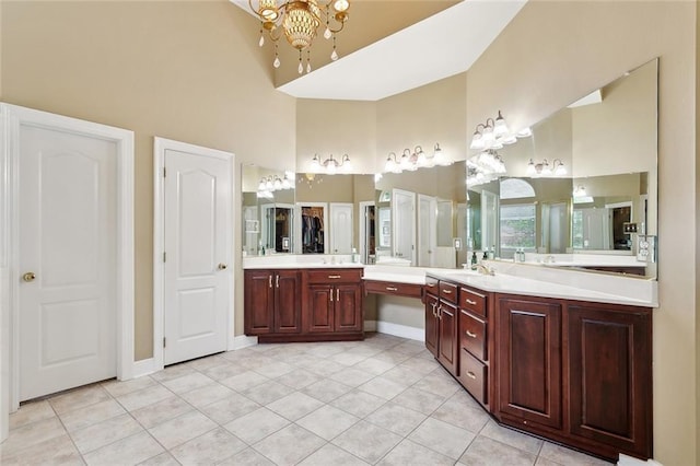 1045 Whitetail Dr, Mandeville, LA 70448 - full bathroom with a chandelier, a towering ceiling, vanity, tile patterned floors, and baseboards