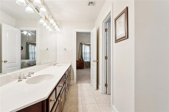1045 Whitetail Dr, Mandeville, LA 70448 - ensuite bathroom with double vanity, tile patterned floors, and baseboards