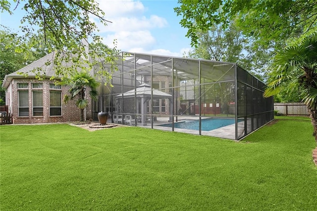 1045 Whitetail Dr, Mandeville, LA 70448 - back of house featuring an outdoor pool, brick siding, glass enclosure, and a patio