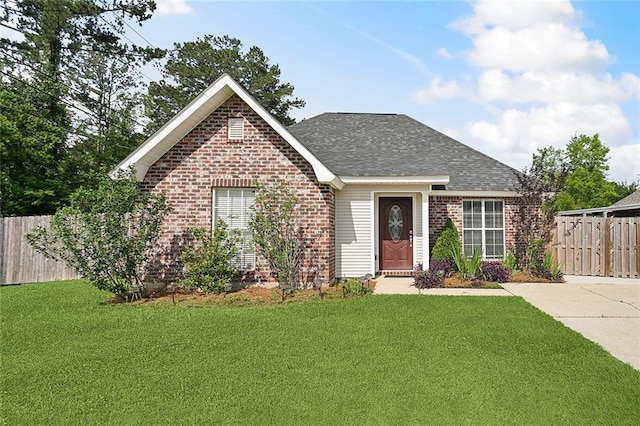 70363 10th St, Covington, LA 70433 - view of front facade featuring brick siding, fence, a shingled roof, and a front yard