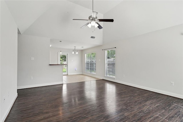 70363 10th St, Covington, LA 70433 - unfurnished living room featuring visible vents, wood finished floors, baseboards, high vaulted ceiling, and ceiling fan with notable chandelier