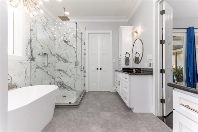 bathroom featuring crown molding, a marble finish shower, vanity, and a freestanding bath